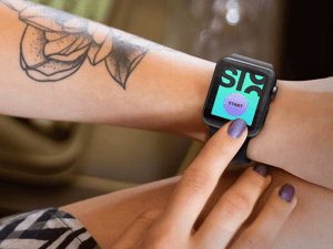 young-tattooed-woman-using-her-black-apple-watch-with-vintage-backdrop